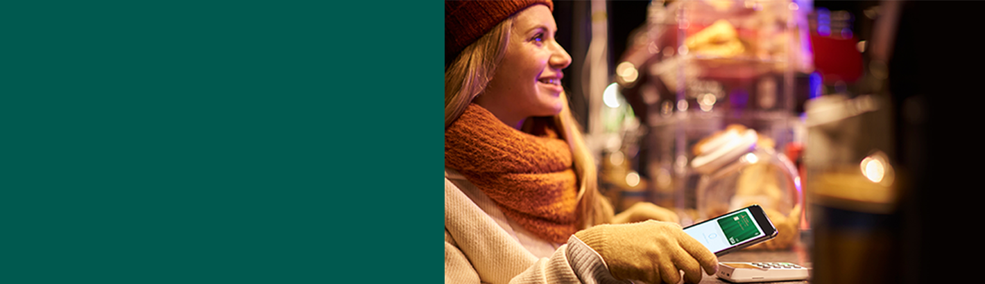 Woman paying at a store with mobile wallet