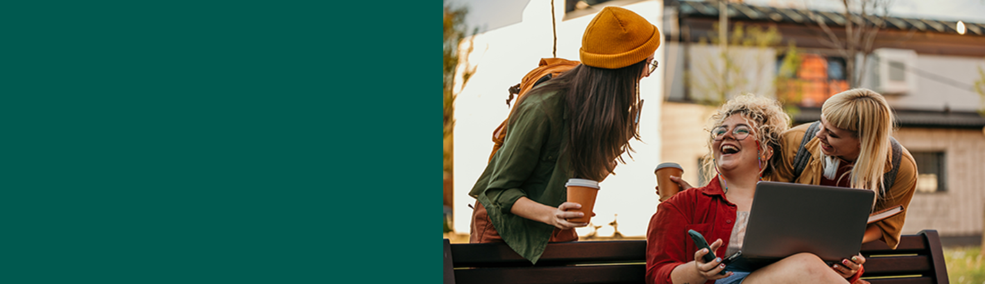 Group of young adults together outside, laughing